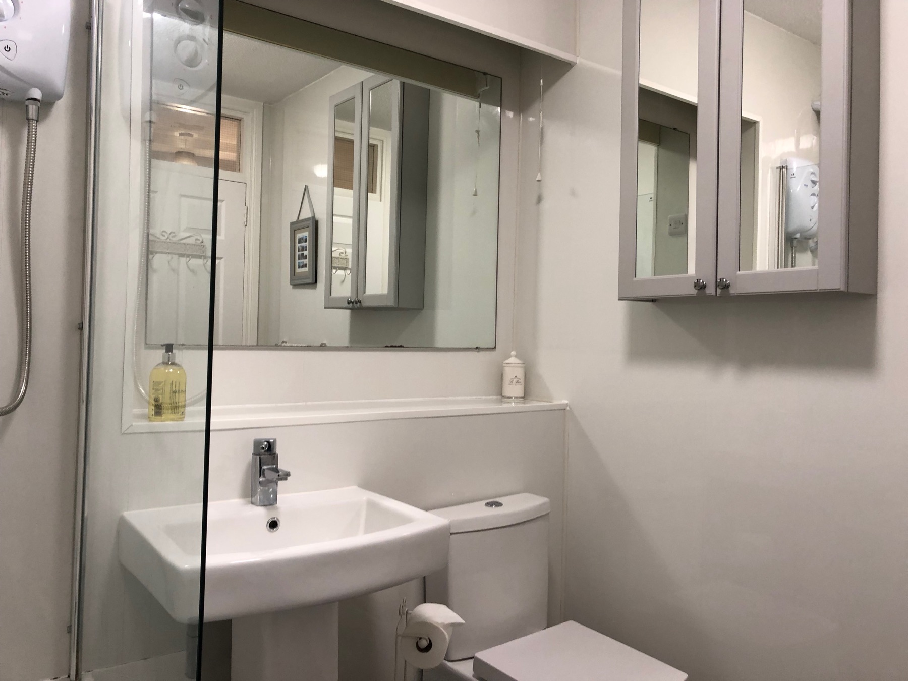 Bathroom with bath and electric shower